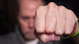 Man with his fist raised - Violent crimes defense in Atlanta, GA