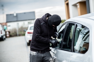 Man breaking into a car - Theft Crimes Attorney in Atlanta